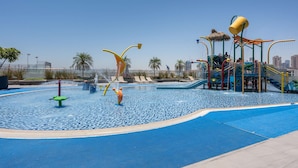 A water play area with slides and a pool. - Free Housekeeping Visits During Your Stay - Stayshort - Stunning Studio in JVT Sleeps 2 With Balcony (Dubai)