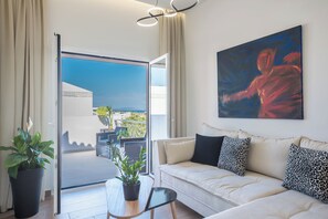 A modern living room with a sofa, a table, and a potted plant. - In  Athenian riviera ,with sea view,800m from the beach, a luxury apartment ! (Voula)