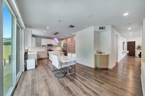 A modern kitchen with a dining area, large windows, and a view of the outdoors. - The Stagg Lane Retreat (Los Angeles)