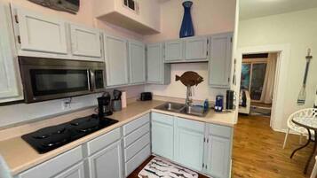 Microwave, stovetop, coffee/tea maker, cookware/dishes/utensils