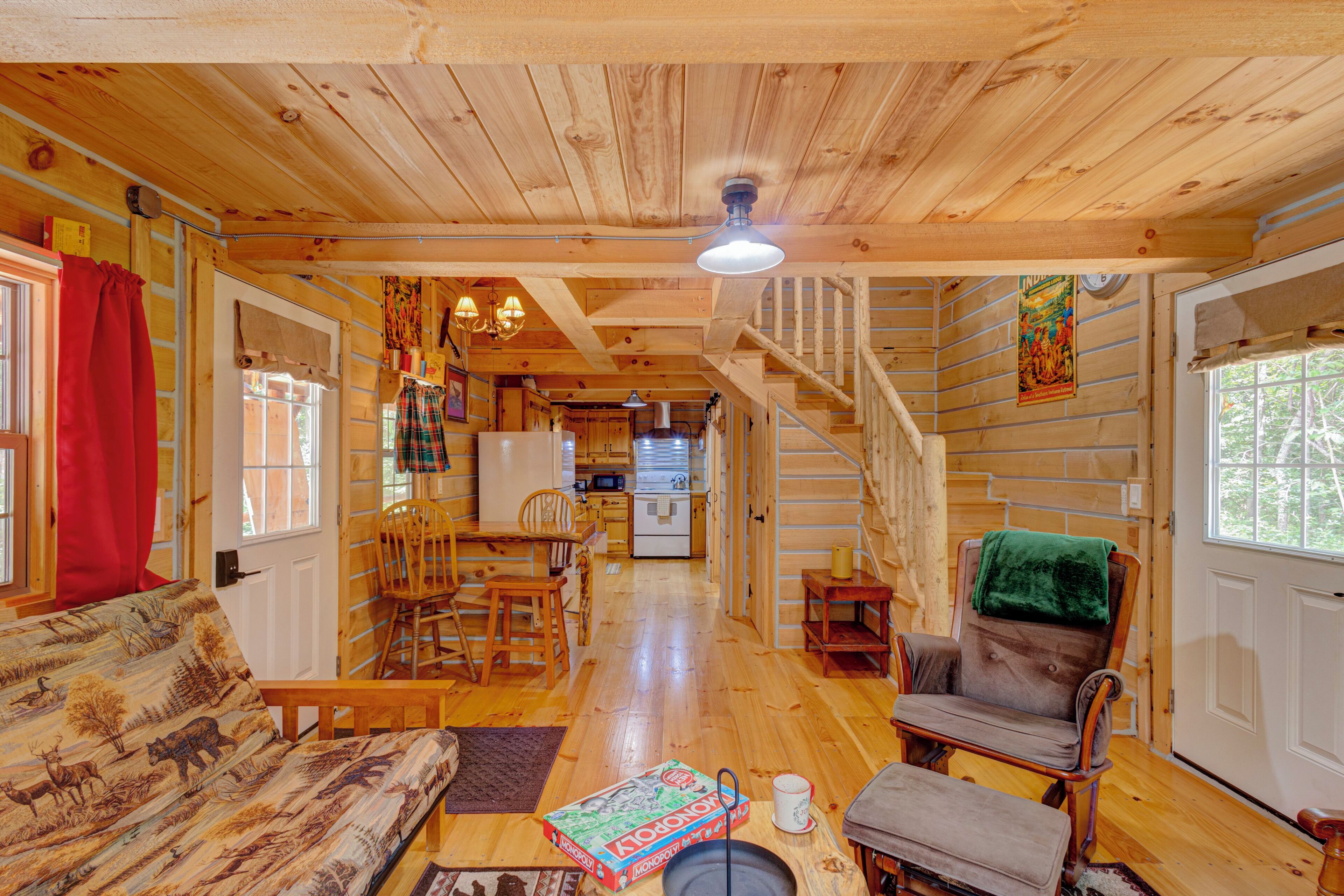 Cozy rustic cabin interior with wood finishes, dining nook, and open layout