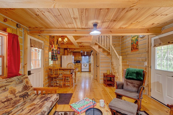 Cozy rustic cabin interior with wood finishes, dining nook, and open layout