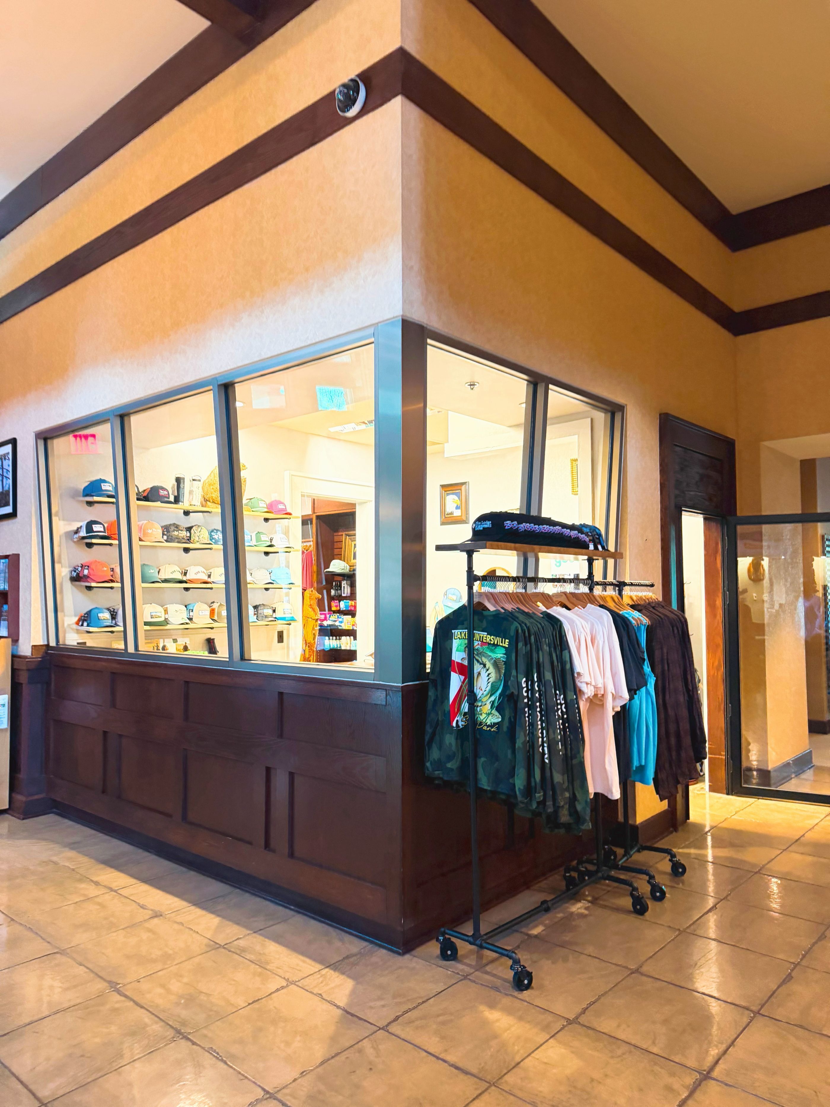 A storefront with a display of hats and clothing racks.