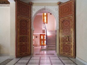A grand entrance with ornate doors and a staircase leading to an upper level. - Villa Zitouna: Luxury Golf, Pool, and Garden in Amelkis + Free Airport Transfer  (Marrakech)
