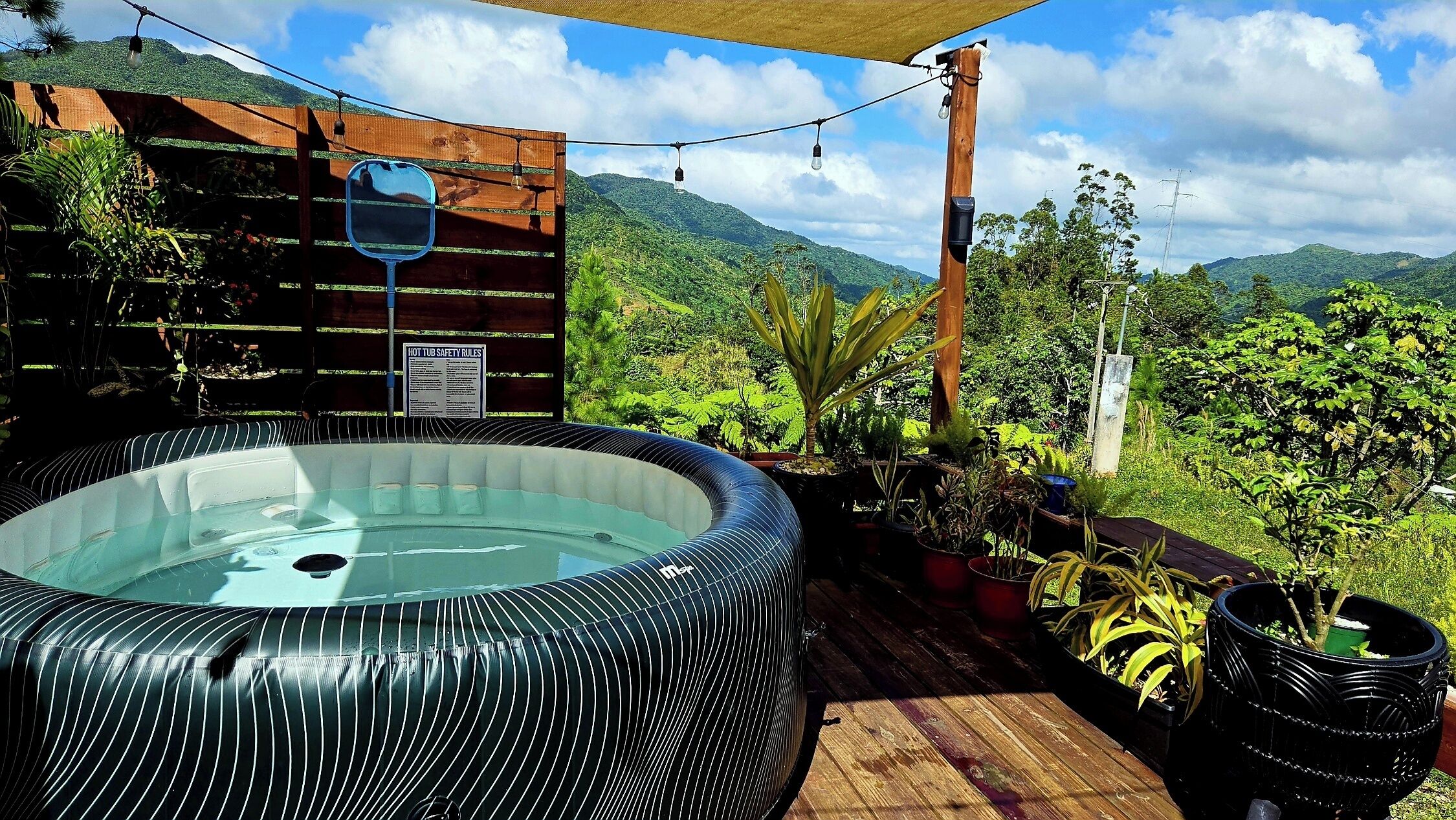 Outdoor spa tub. Botanical Hot tub- cabin with AC in Mountains of Orocovis