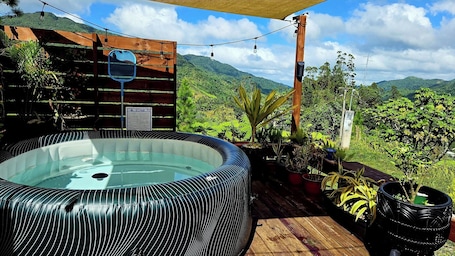 Outdoor spa tub. Botanical Hot tub- cabin with AC in Mountains of Orocovis