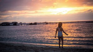 A person standing on a beach during sunset. - Luxury Golf-Front Villa: 6BR w/ Private Pool, Chef & Golf Cart (Punta Mita)