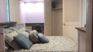 A bedroom with a bed, a desk, a wardrobe, and a window with blinds. - Beautiful In-law suite in Palmyra PA. No Cleaning Fees. (Palmyra)