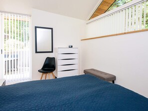 A bedroom with a bed, a chair, a dresser, and a bench. - 5 Star Holiday Home in Ans By (Ans)