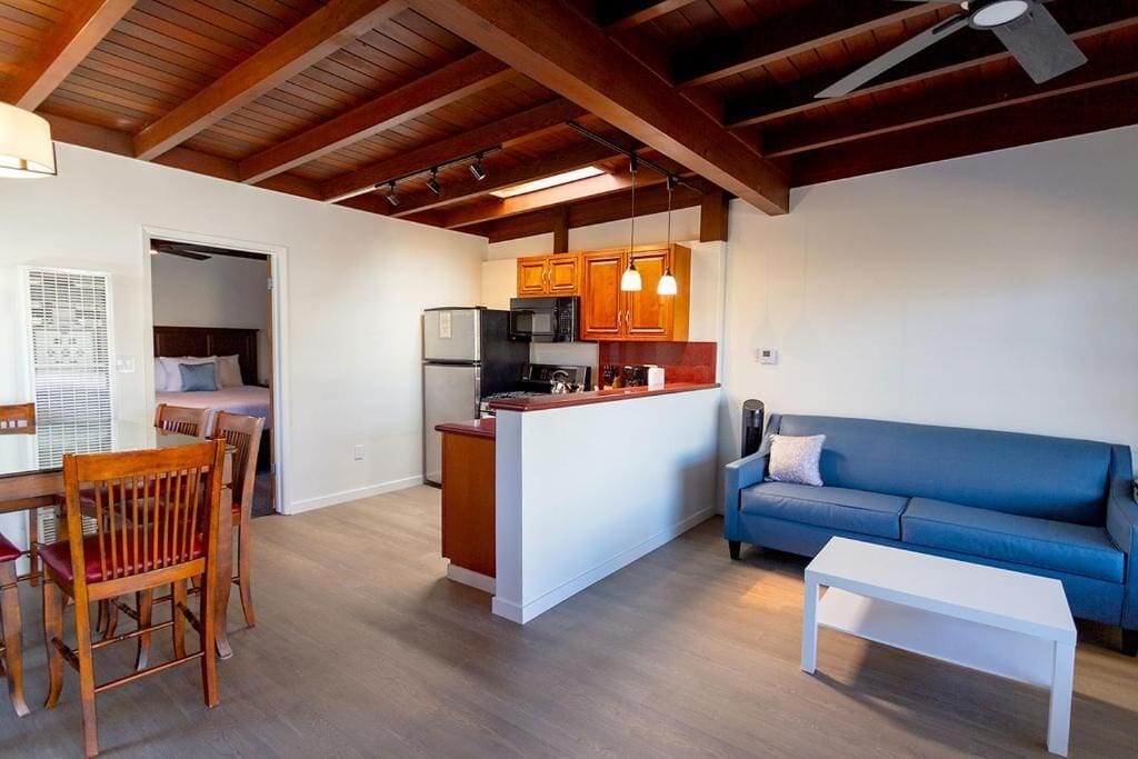 A compact living space with a kitchenette, a dining area, and a seating area.