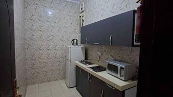Appartement Familial, vue ville | Cuisine privée | Mini réfrigérateur, micro-ondes, four
