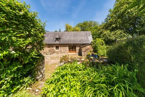 A stone house with a sloped roof, a wooden door, and a small window. - Le Penty - Plouguiel (Plouguiel)