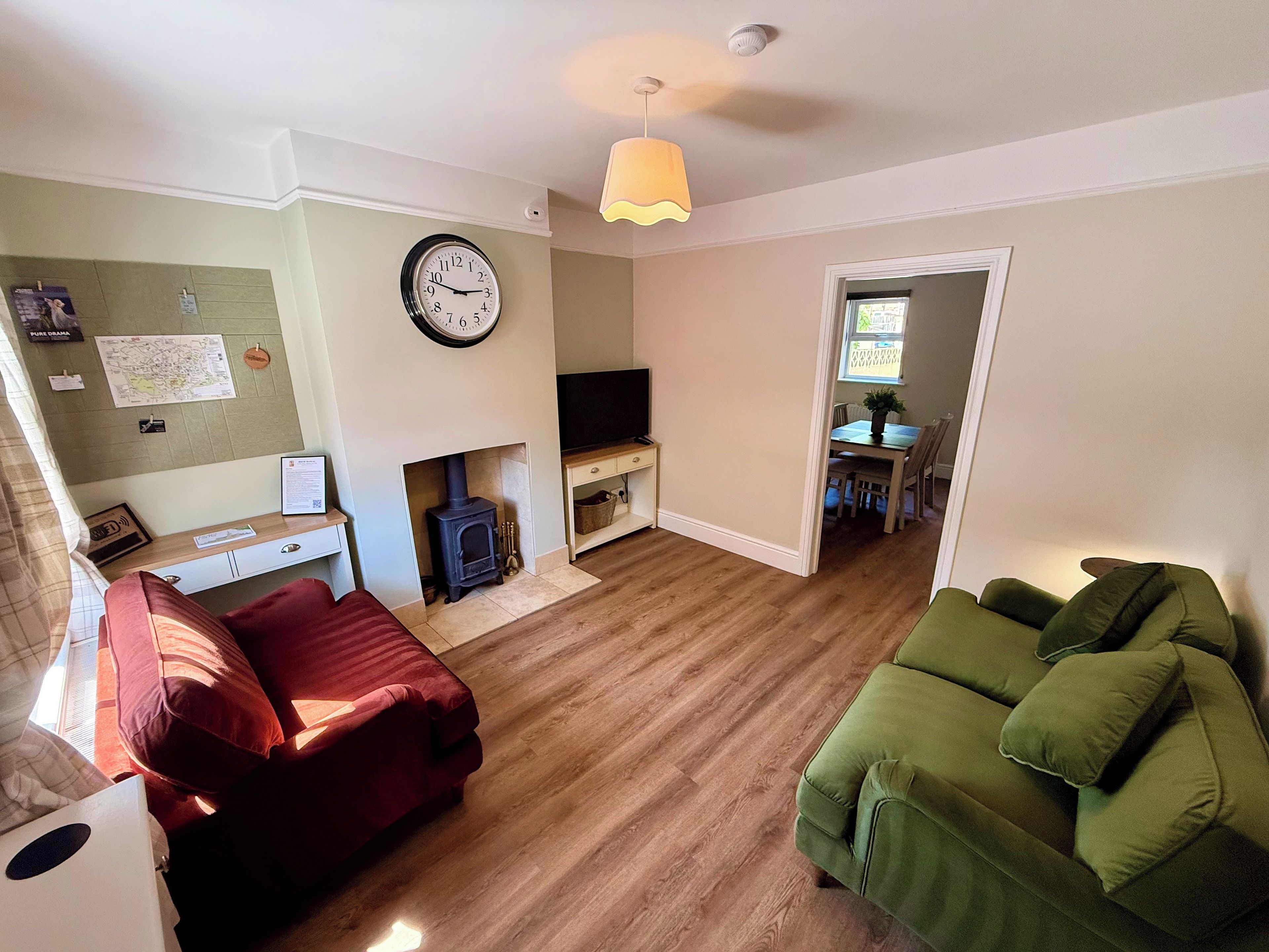 Bright lounge with log burner, Smart TV and two sofas