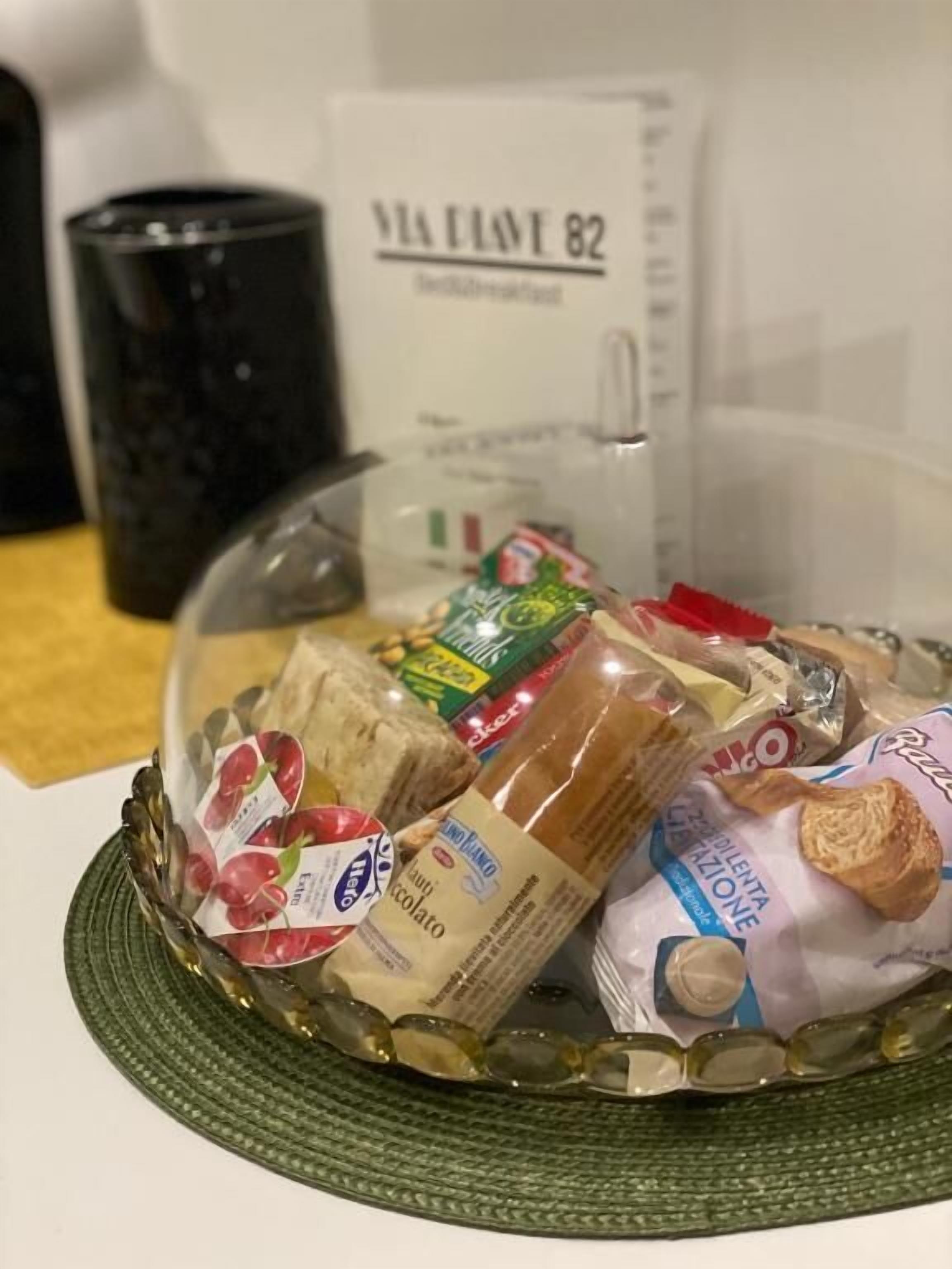 A clear glass bowl containing various food items on a table.