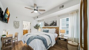 A bedroom with a bed, bedside table, chair, and a ceiling fan. - RiverStone Resort • Upscale 1BR•1BA Condo · Sleeps 4• Lazy River•Pool•Hot Tubs (Pigeon Forge)