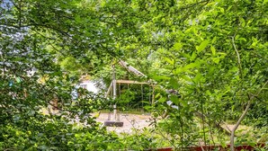 A swing set surrounded by dense foliage. - "Elif" - 200m from the sea by Interhome (Nordborg)