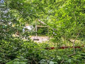 A swing set surrounded by dense foliage. - "Elif" - 200m from the sea by Interhome (Nordborg)