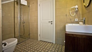 Un baño con inodoro, ducha y lavamanos.