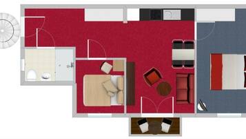 A hotel layout with a kitchen, dining area, two bedrooms, a bathroom, and a small balcony.