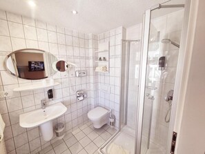 A bathroom with a sink, toilet, and shower. - Villa Meeresgruss (Binz)