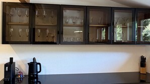 A kitchen with a black countertop, a coffee maker, and a knife block. - Your time-out with a view of the Alps and the Kander (Kandergrund)