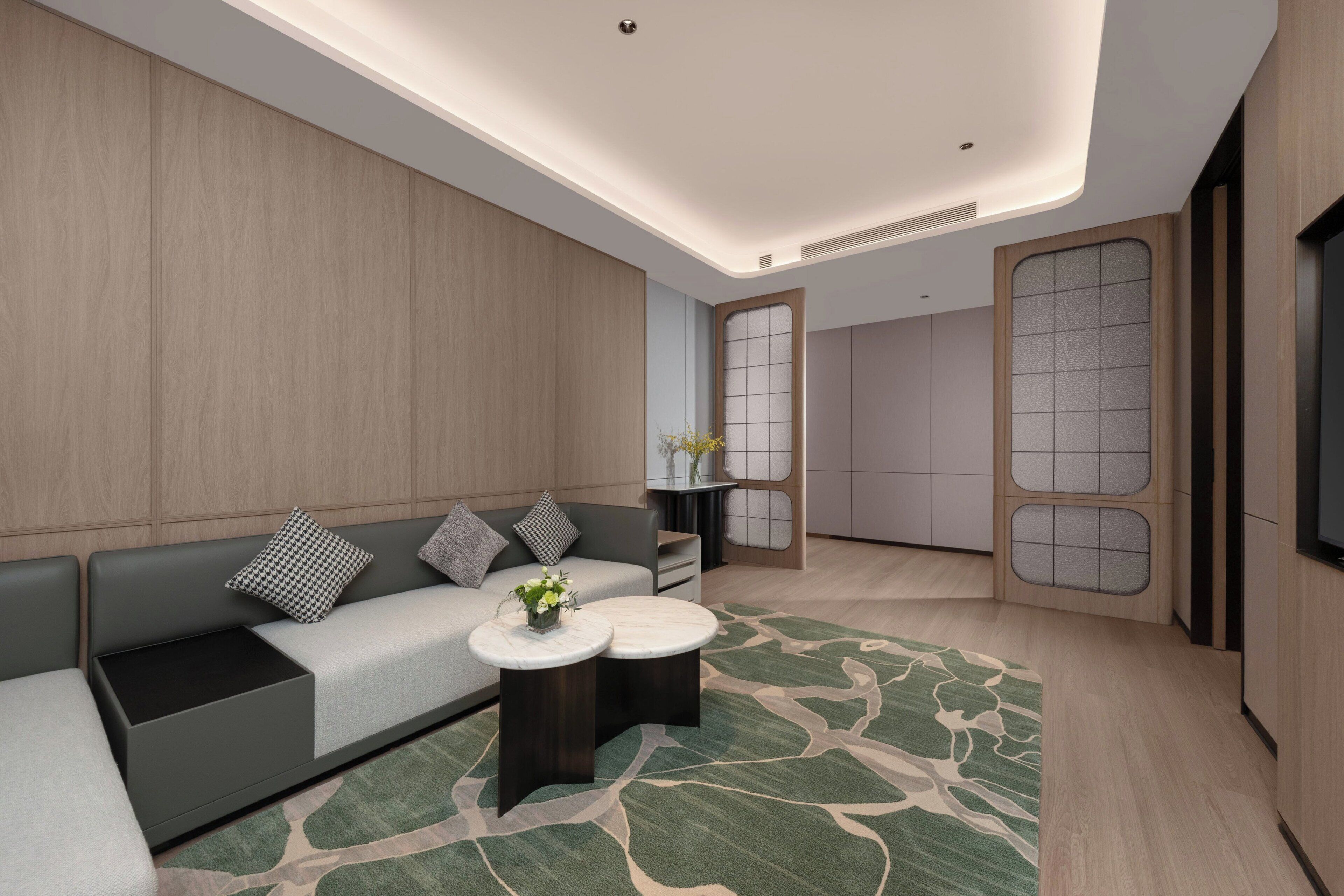 A modern living room with a sofa, coffee table, and decorative vase.