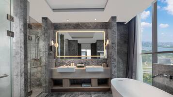 A modern bathroom with a large mirror, two sinks, a bathtub, and a shower.