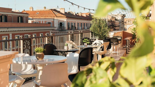 A terrace with outdoor seating, a view of the cityscape, and a railing. - Ruby Lilou Hotel Marseille by IHG (Marseille)