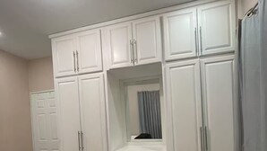 Ein Schlafzimmer mit Bett, Kleiderschrank und Spiegel.