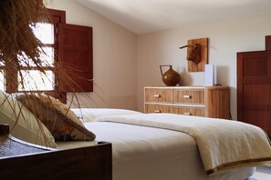 A bedroom with a bed, wooden dresser, and a vase on the dresser. - Finca Vegachi - Five Bedroom Villa, Sleeps 10 (Algatocín)