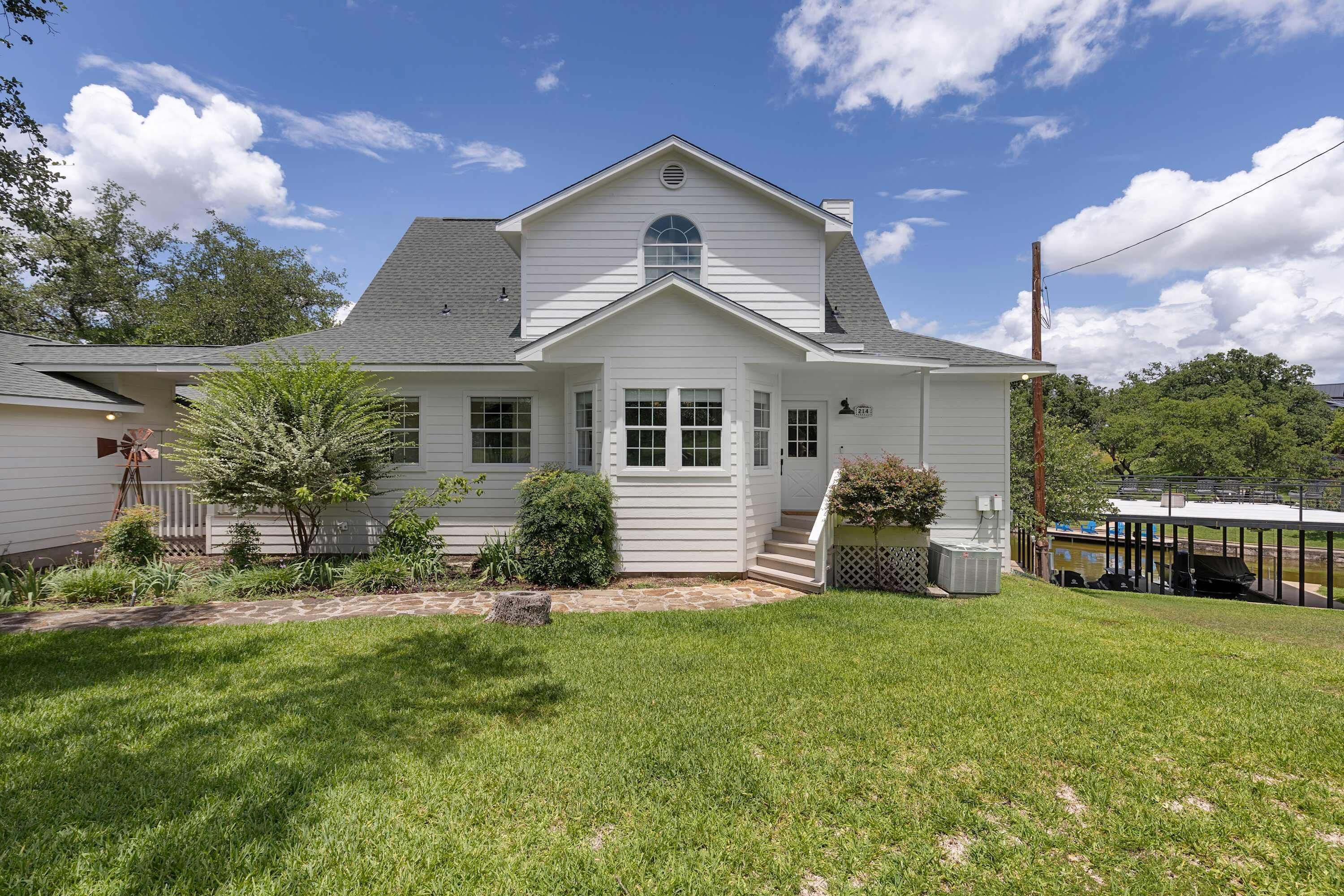 A single-story house with a front porch, a small front yard, and a garage.