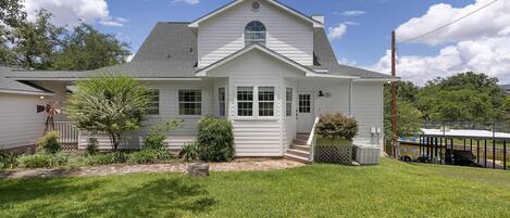 A single-story house with a front porch, a small front yard, and a garage.