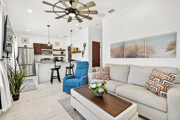 A modern kitchen with a microwave, stove, and dining area.