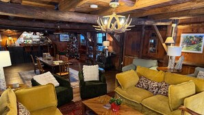 A cozy interior with a bar area, wooden furniture, and a Christmas tree. - The Landgrove (Londonderry)