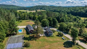 An aerial view of a residential area with houses, a tennis court, and a swimming pool. - The Landgrove (Londonderry)