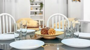 A dining table with plates, glasses, and a centerpiece. - Designer 4BR Basement Suite – Oakville (Oakville)