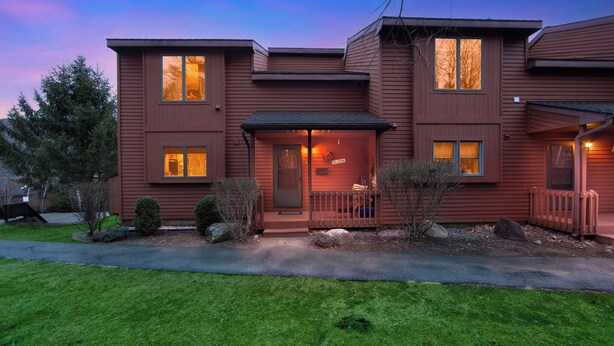A two-story house with a front porch, a welcome sign, and a well-maintained lawn. - Otterslide by Avantstay Heated Pool + Game Room Near Gore Mtn (North Creek)