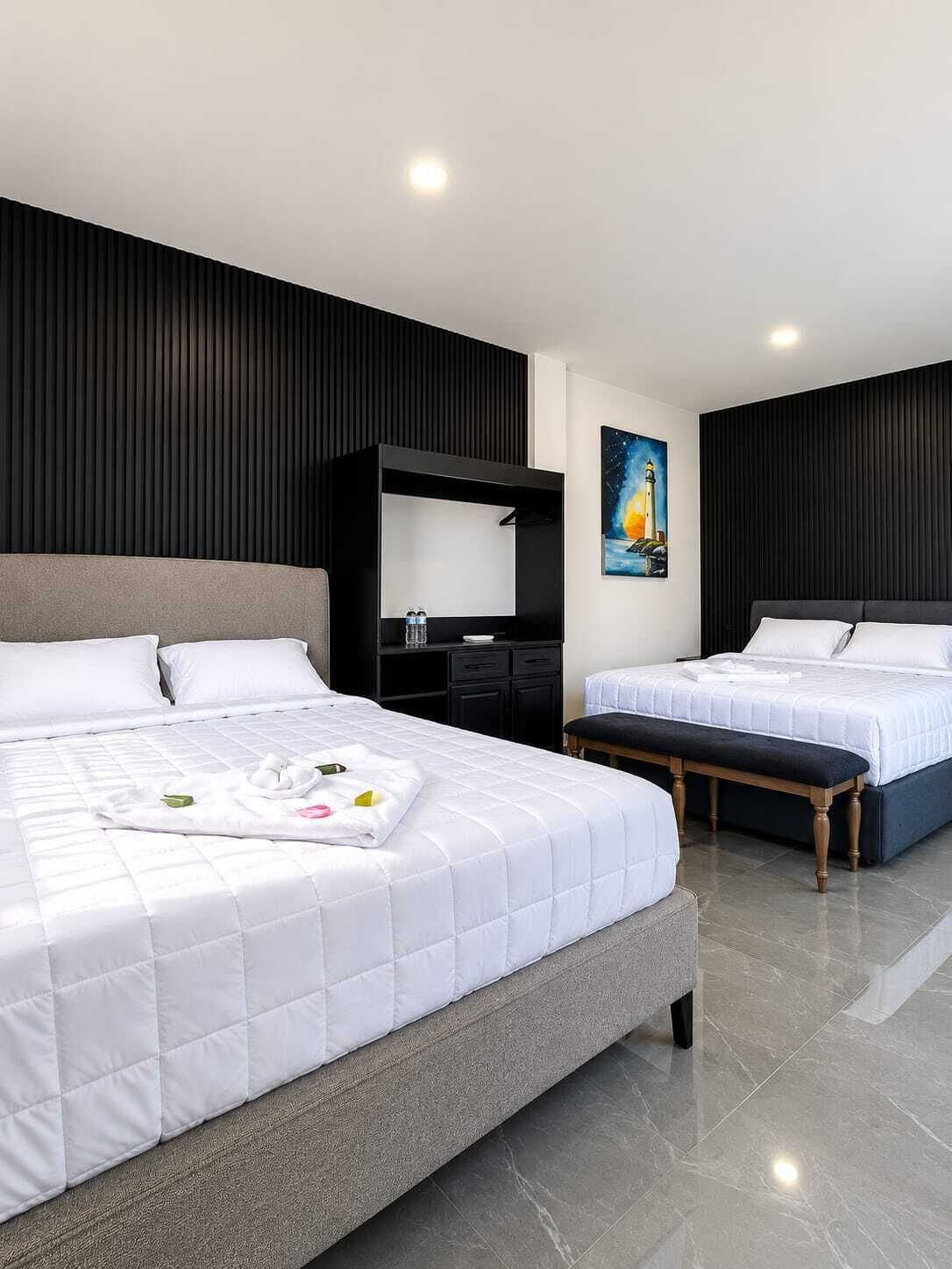 Habitación Deluxe, vista a la playa | Caja de seguridad en la habitación y cortinas blackout 