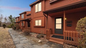 A two-story wooden house with a porch, a front door, and a mailbox. - Tahawus by Avantstay Sauna + Indoor Heated Pool + Rec Lounge Near Gore Mtn (North Creek)