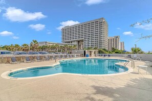 A hotel with a large pool, sun loungers, and a high-rise building in the background. - N Hampton 222 in Kingston, Oceanfront, Pool, Beach (Myrtle Beach)