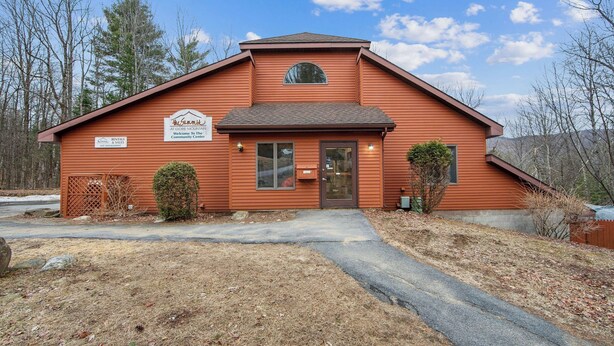 A small, single-story building with a pitched roof, a front door, and a small window above the door. There is a sign on the building that reads 'The Summit at Gore Mountain Welcome To The Community Center.' - Chatiemac by Avantstay Wood Fireplace + Resort Pool + Game Room Ski Retreat (North Creek)