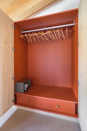 Ein Schrank mit Holzprogrammen, einem kleinen Gerät und zwei Schubladen.
