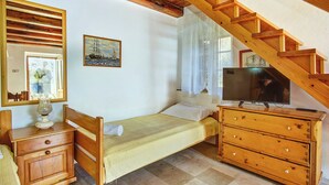 A bedroom with a wooden bed, a dresser, a television, a painting, and a window with curtains. - Apartment 2440/244326 (Kvarner - Martinšćica), 200m from the beach (Martinšćica)