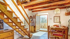 A wooden staircase leading to a balcony with a dining area and a view of trees. - Apartment 2440/244326 (Kvarner - Martinšćica), 200m from the beach (Martinšćica)