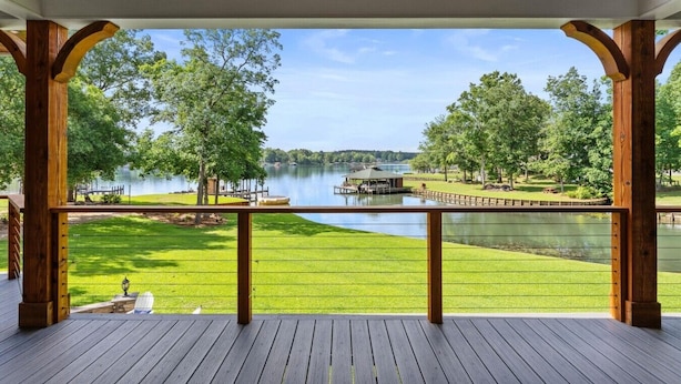A covered deck with a view of a lake, wooden deck, and a grassy area. - Lake Sinclair Paradise|Beach|Game Rm|Dog-Friendly (Eatonton)