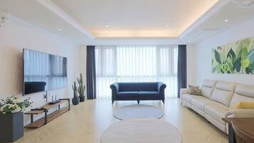 Family Suite, Non Smoking, City View | Living area | 50-cm TV with cable channels, pay films