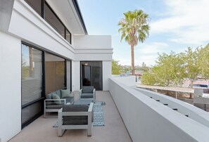 A modern balcony with a sofa, chairs, and a table. - Zeta - Private Balcony - In Old Town Scottsdale (Scottsdale)
