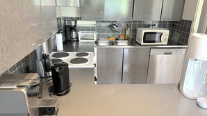 A modern kitchen with stainless steel appliances, a microwave, and a dishwasher. - Helsinki Airport & City Center Gateway (Helsinki)