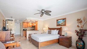 A hotel room with a bed, a desk, a chair, a dining area, and a kitchen. - New Listing Lahaina Shores 412 Beach Front Resort (Lahaina)
