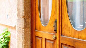 A wooden door with a brass handle and a keyhole.